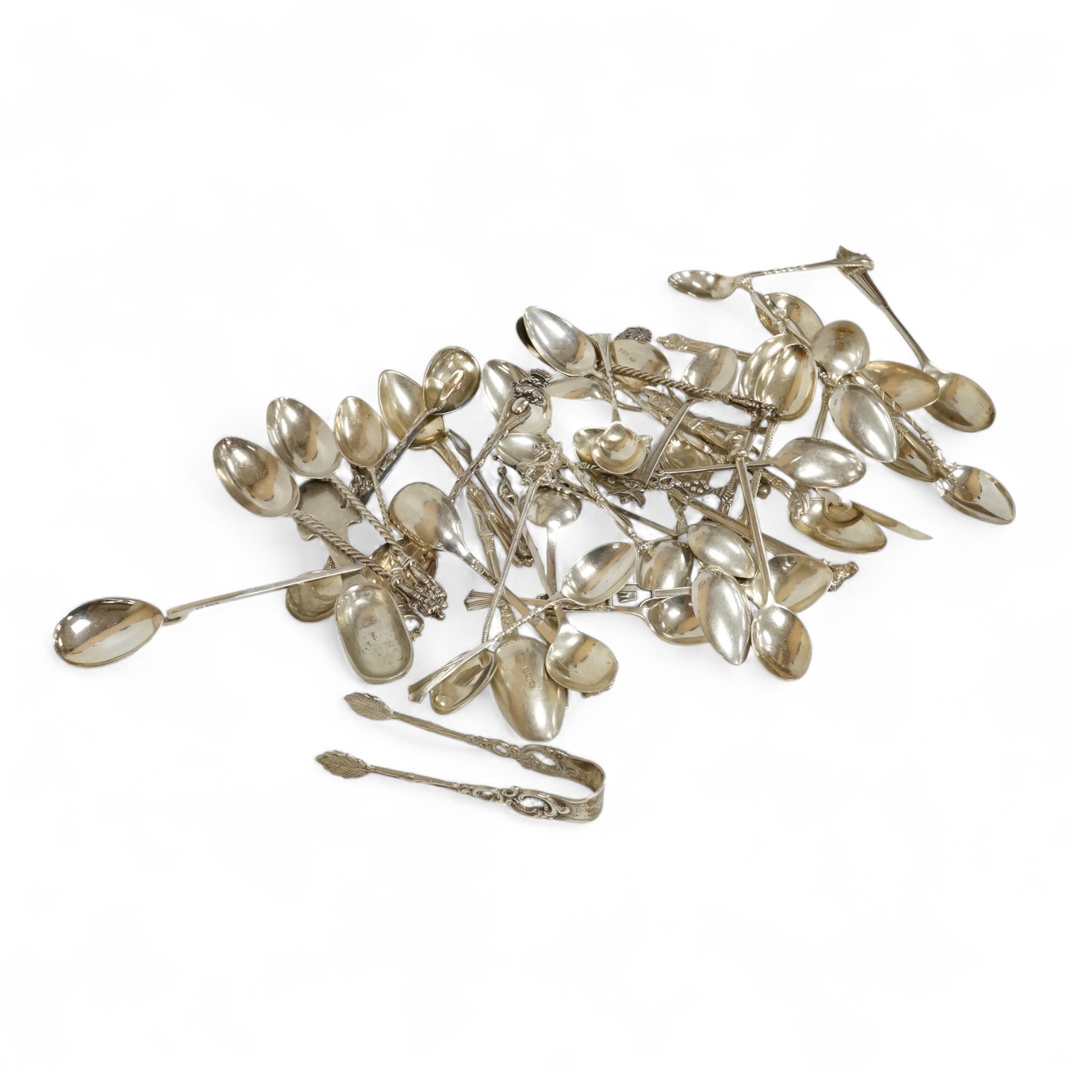 A group of assorted silver and white metal tea and coffee spoons and a pair of silver sugar tongs, weighable hallmarked silver 8.6oz.